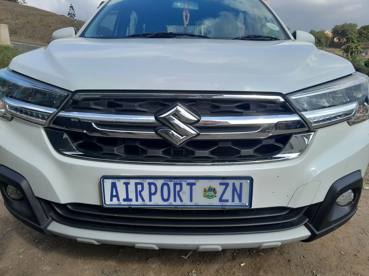 Suzuki XL7 front view with Airport ZN plate at King Shaka Airport