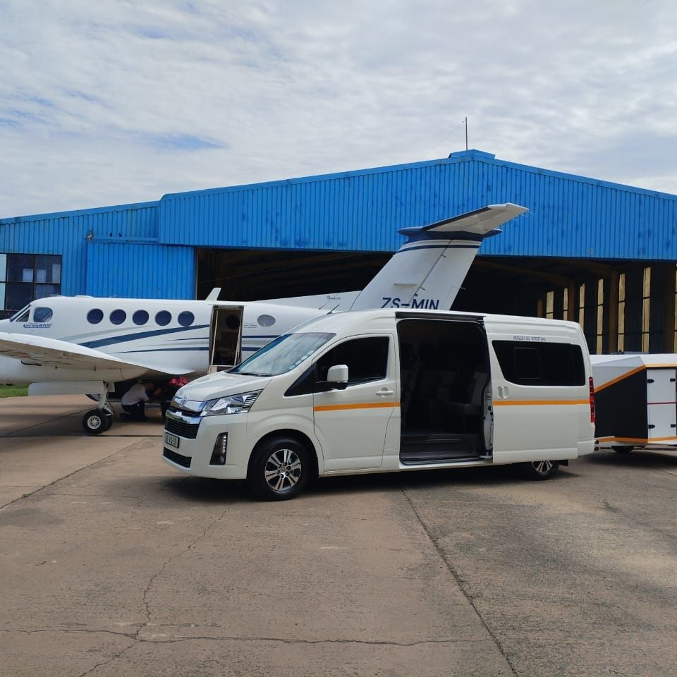 Toyota Hiace shuttle and luggage trailer meeting a private charter flight