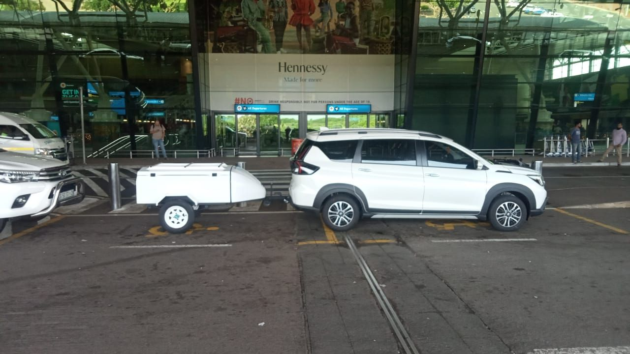 SUV with luggage trailer waiting at King Shaka Airport departures