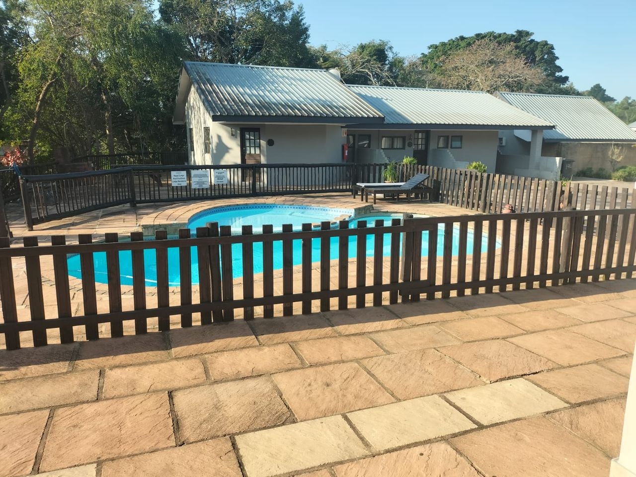 Pool deck and garden chalets at a partner lodge near the reserves