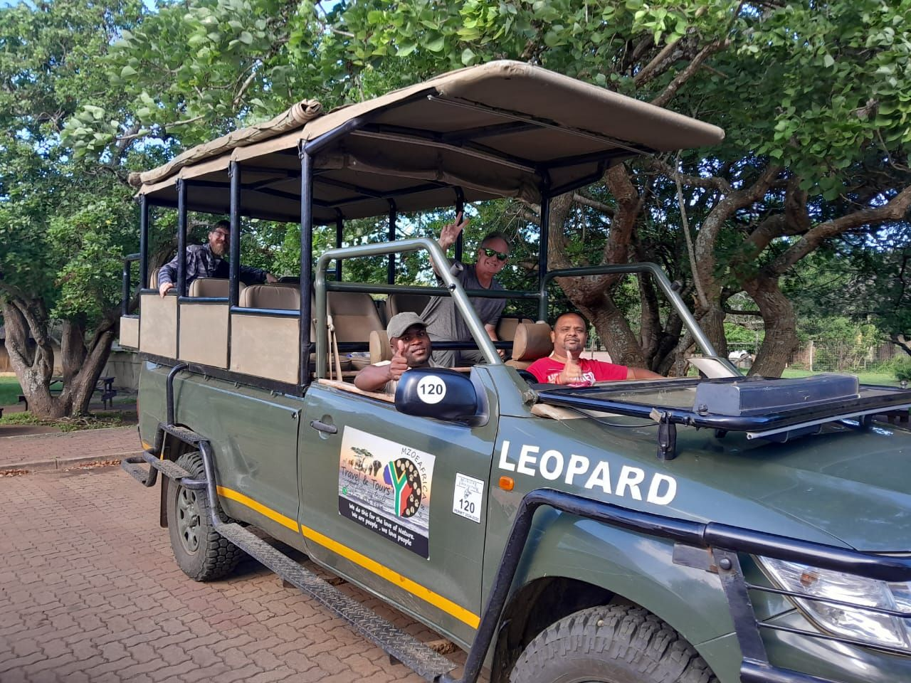 Guests and guide in the Leopard open safari vehicle before a game drive