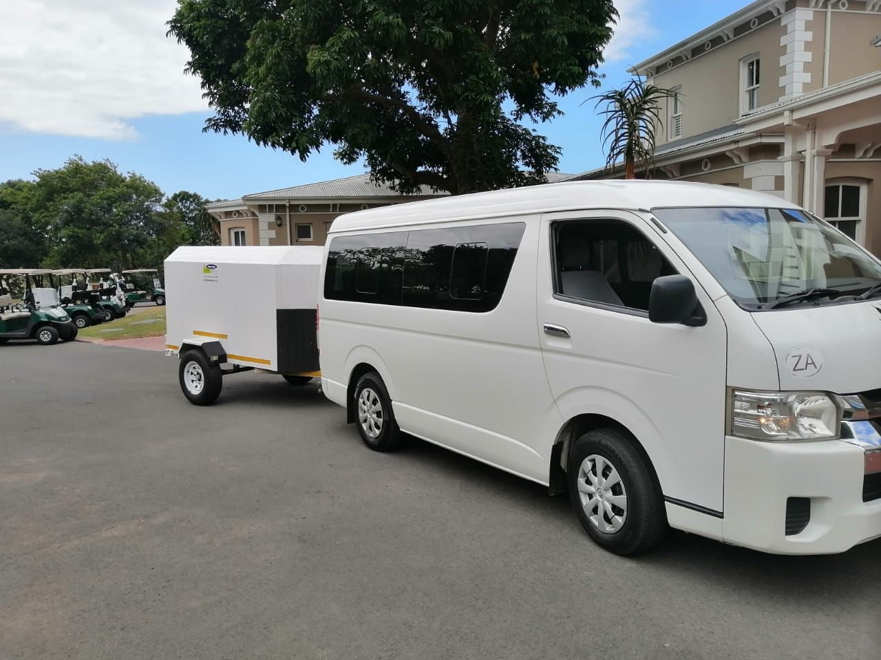 Toyota Quantum minibus towing a luggage trailer